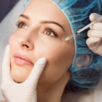 Close-up of female patient receiving an injection on her face in clinic
