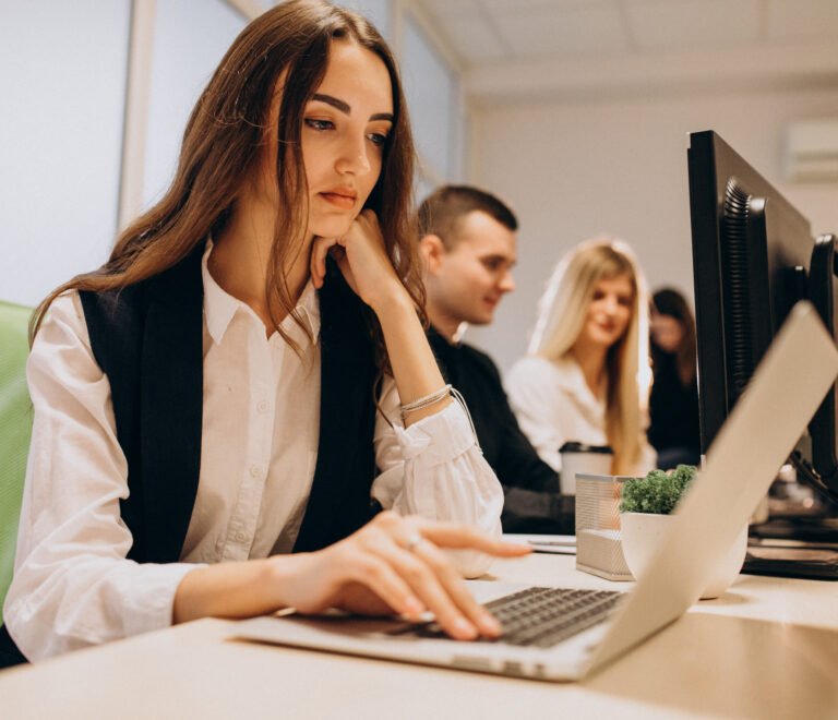 Workers at an IT company working on a computer