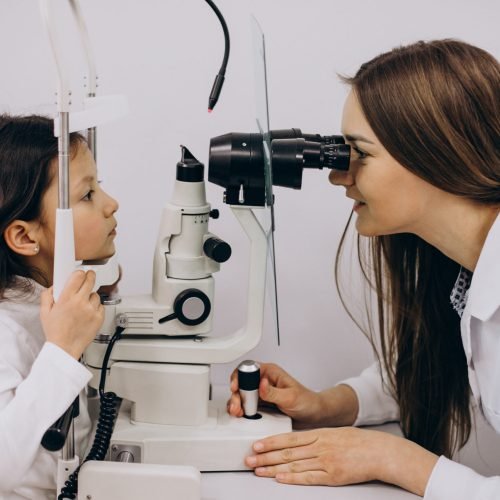 Little girl checking up her sight at ophthalmology center