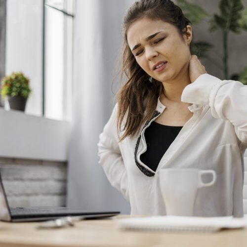 woman-having-neckache-while-working-home